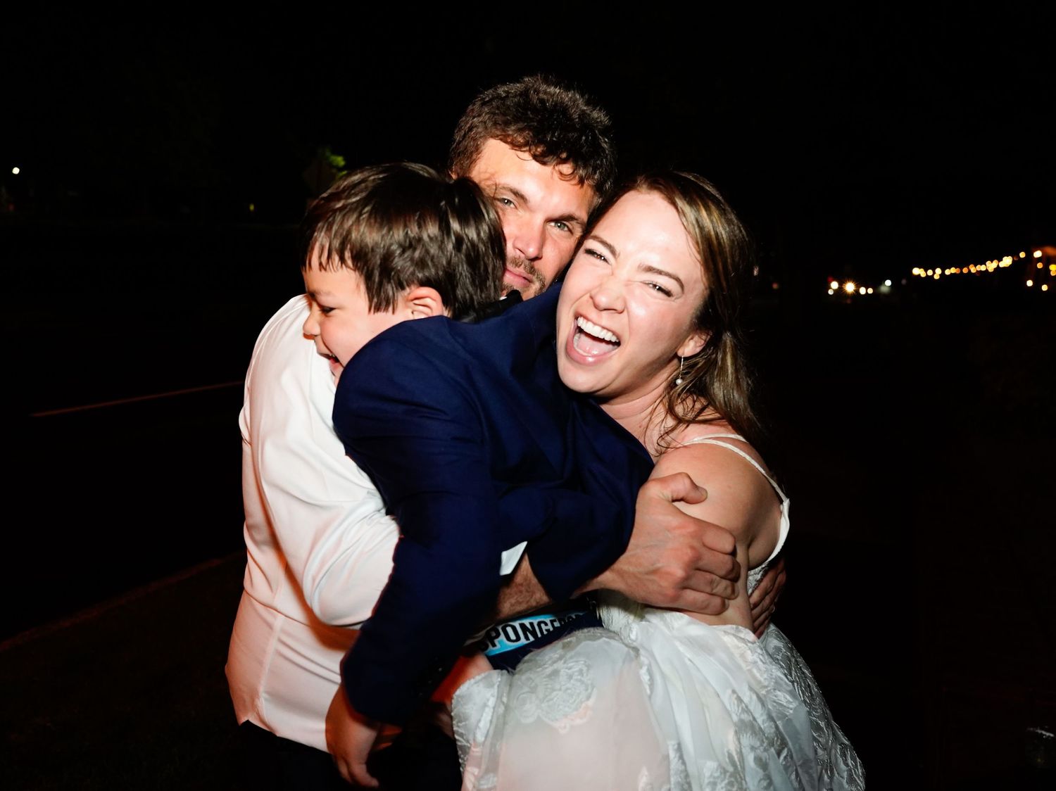 A couple shares an intimate dance moment at what appears to be a wedding reception or formal event.