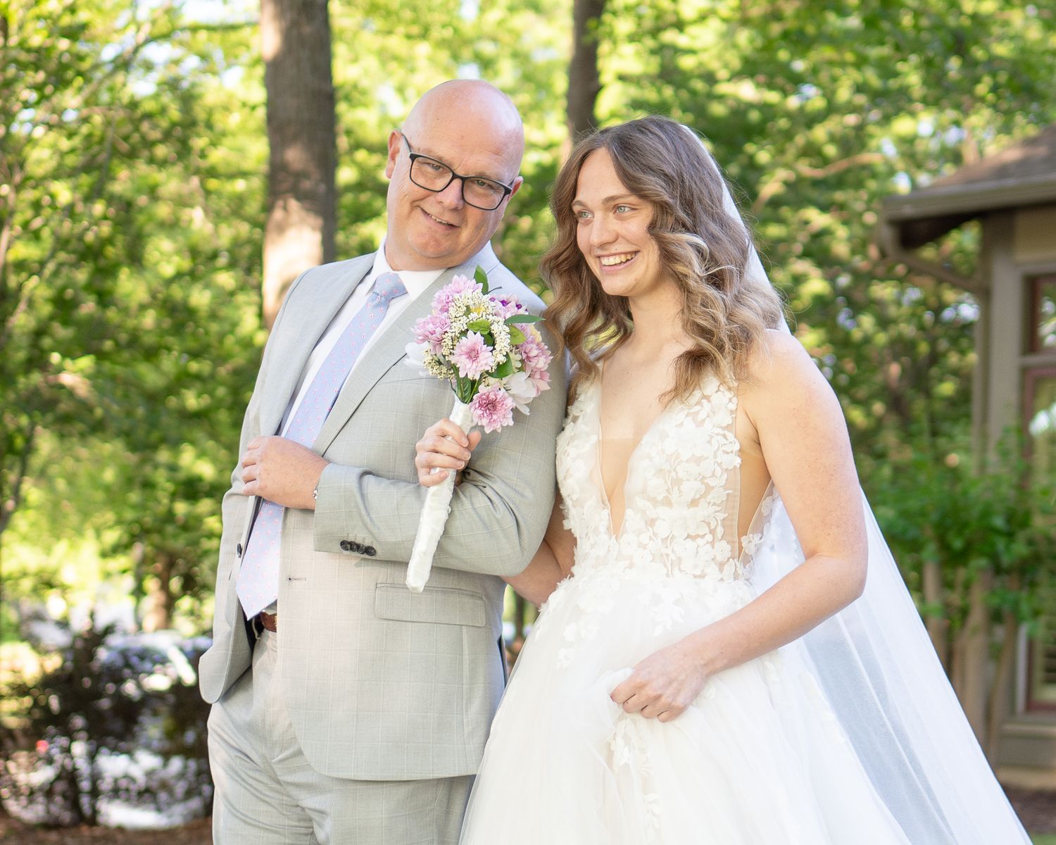 Wedding celebration in a garden setting with formal attire and natural lighting.