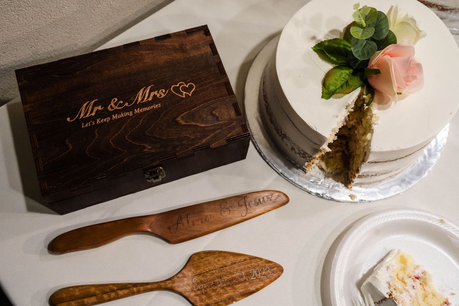 Elegant wedding cake set with engraved wooden Mr & Mrs keepsake box and personalized cake cutting utensils.