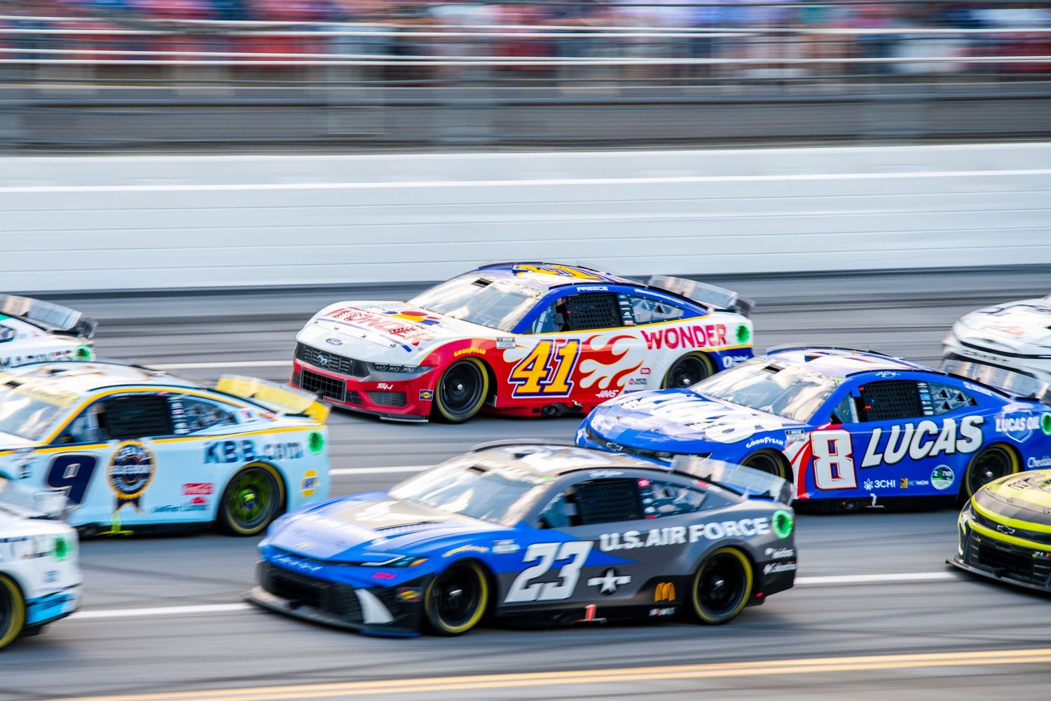 NASCAR Cup Series cars including US Air Force number 23 racing at Talladega.