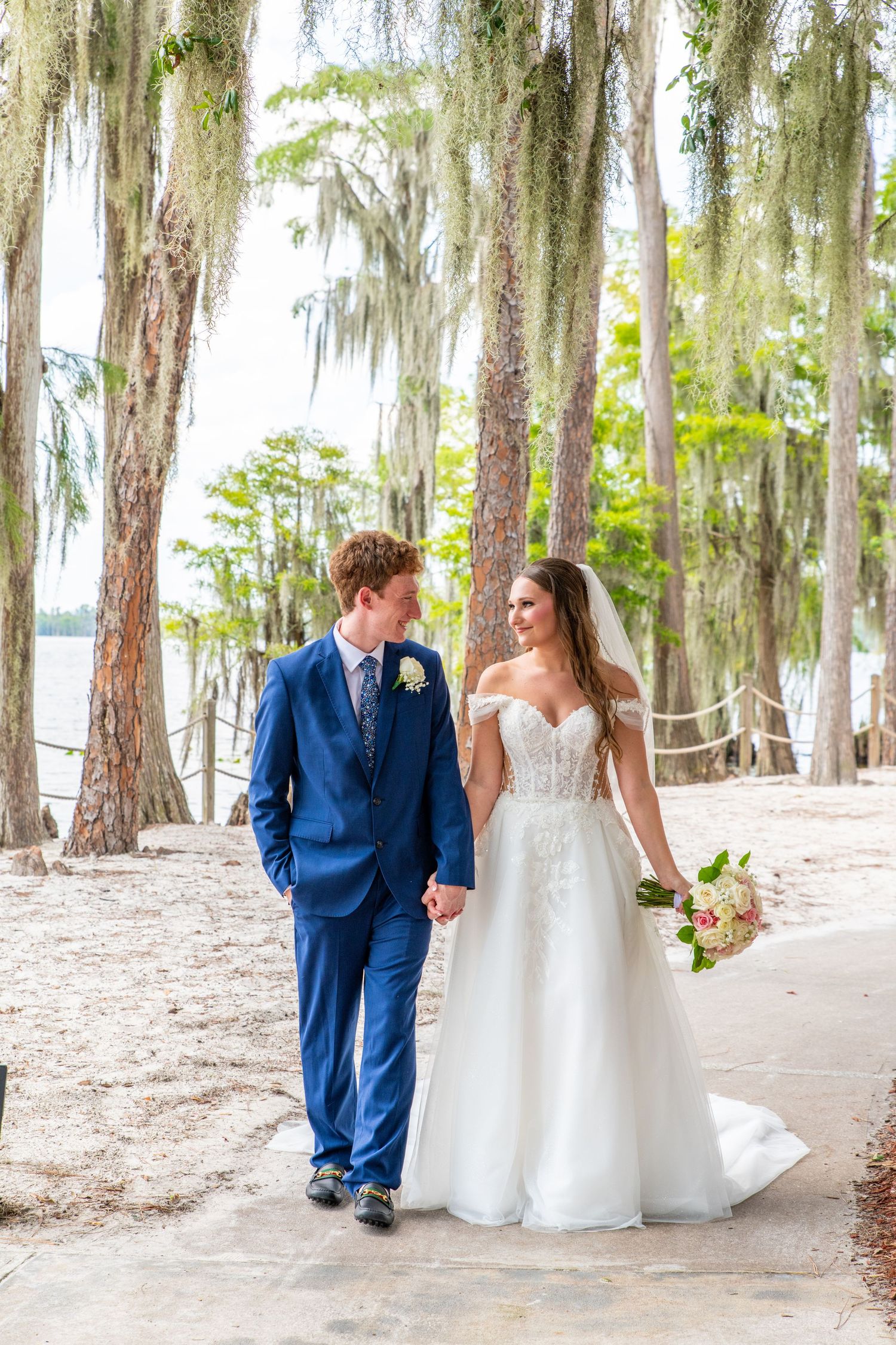 bride and groom holding hands walking at beach wedding in central florida