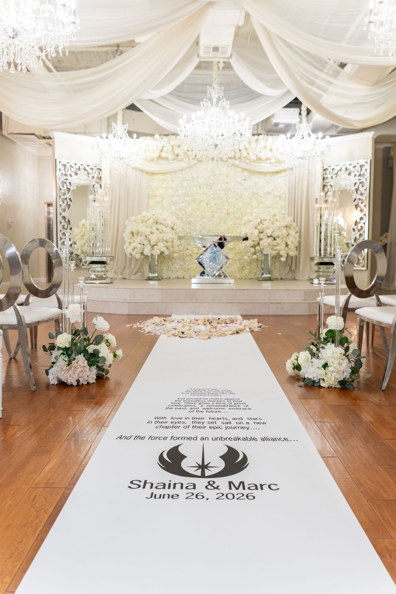 Star Wars themed wedding aisle runner for Shaina & Marc, June 26, 2026, in an elegant white floral venue.