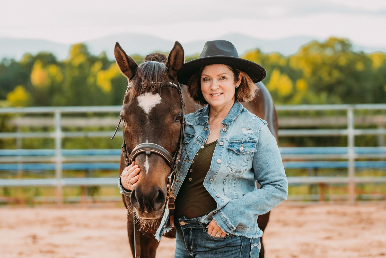 horse and rider pose for photo in front of orthopedic Georgia mountains in area for portrait session