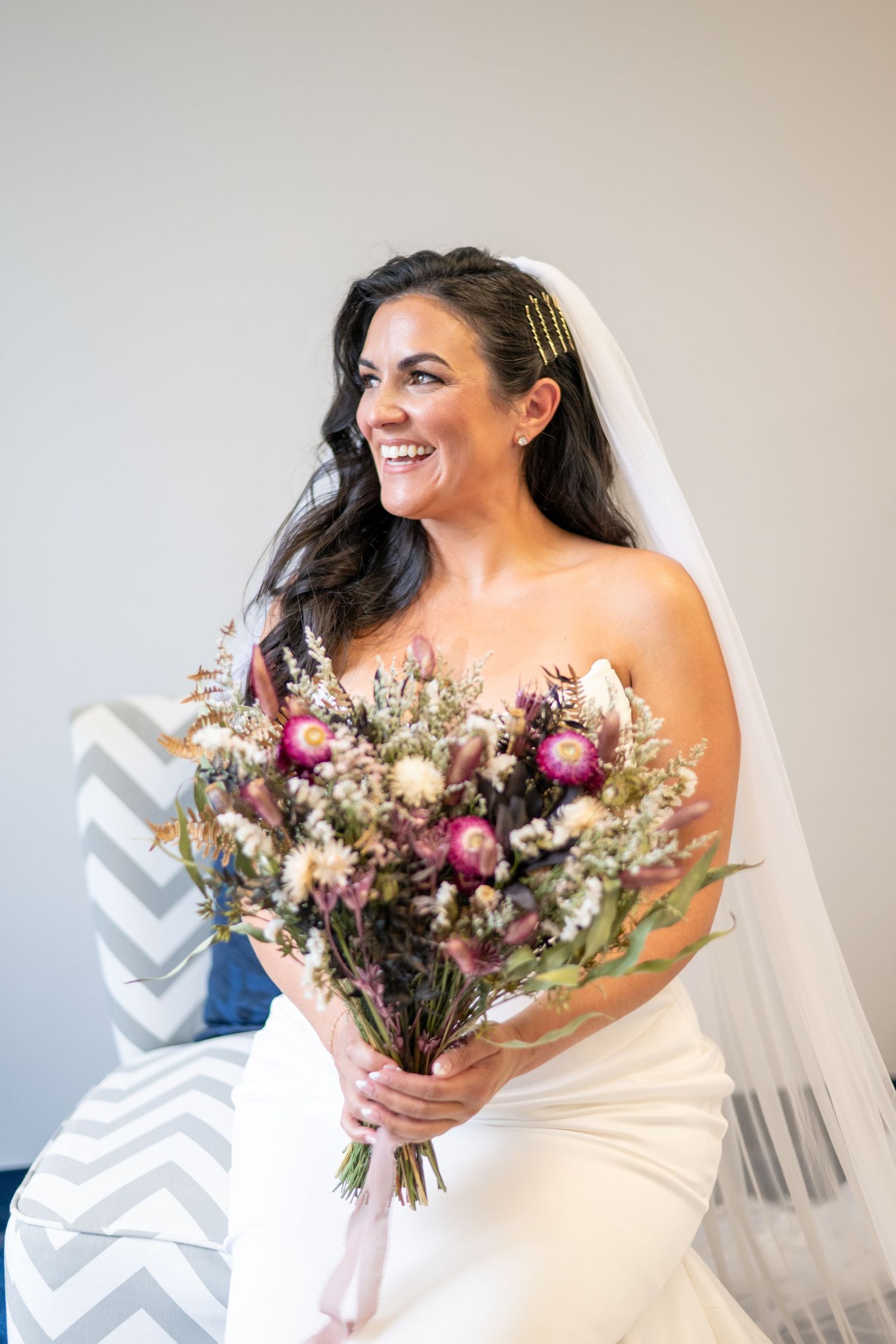 bride posing for portrait at altomante chapel holding bridal boquet