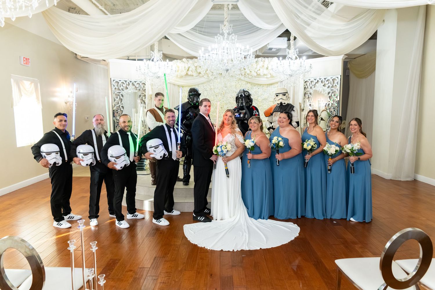 Star Wars themed wedding party with Darth Vader, Stormtroopers, bride, groom, and wedding party in blue dresses.