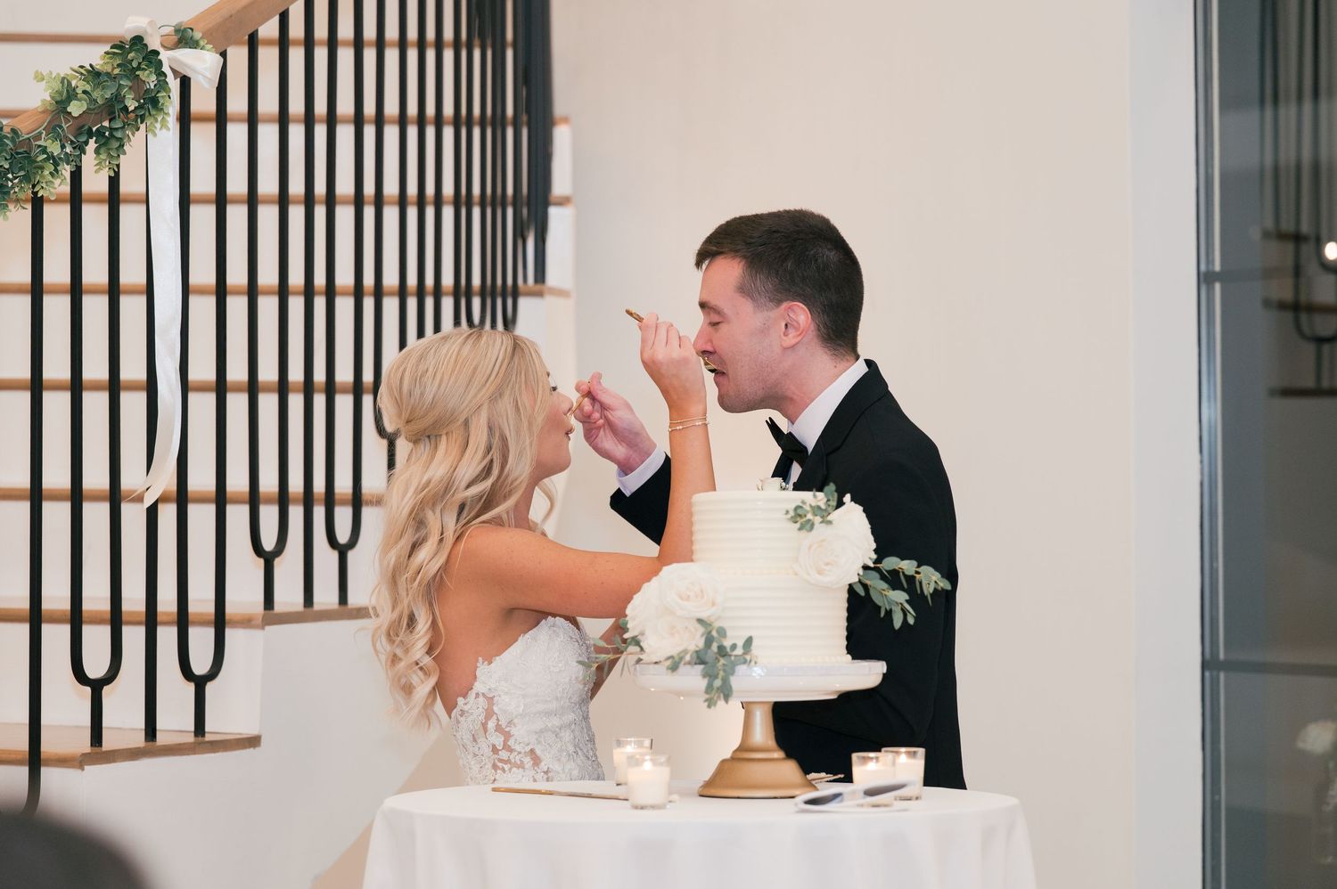 fun wedding reception picture of cutting the cake in McMinnville, TN at The Monroe