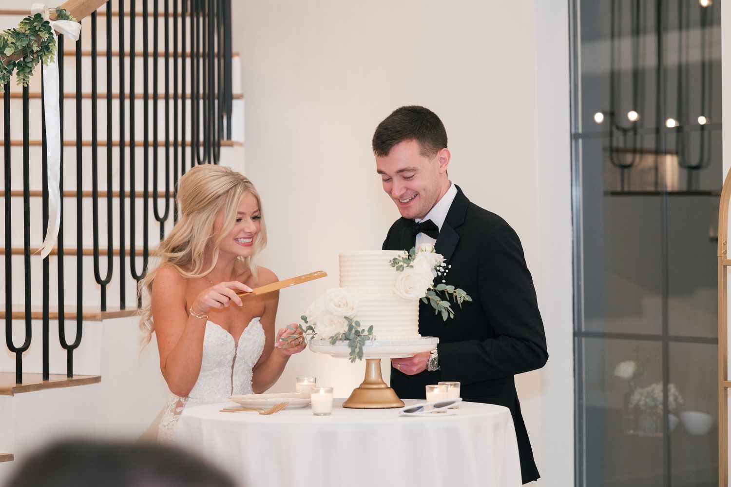 fun wedding reception picture of cutting the cake in McMinnville, TN at The Monroe