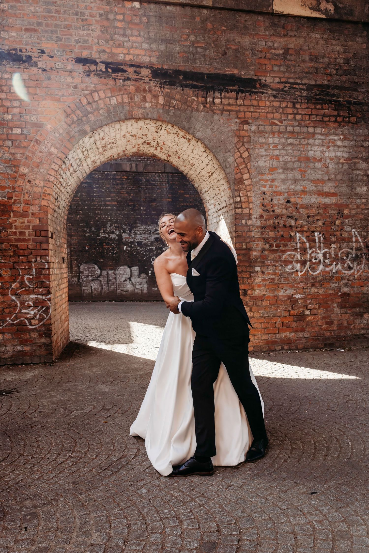 Wedding couple portraits against industrial brick archways and walls at Castlefield, Manchester.  Manchester City Centre Wedding.