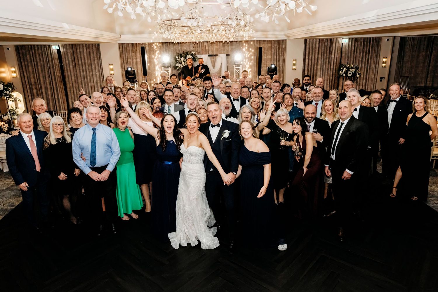 Large wedding reception crowd gathered in an elegant ballroom under crystal chandeliers at the Crow Wood Hotel and Spa, Burnley.  Lancashire