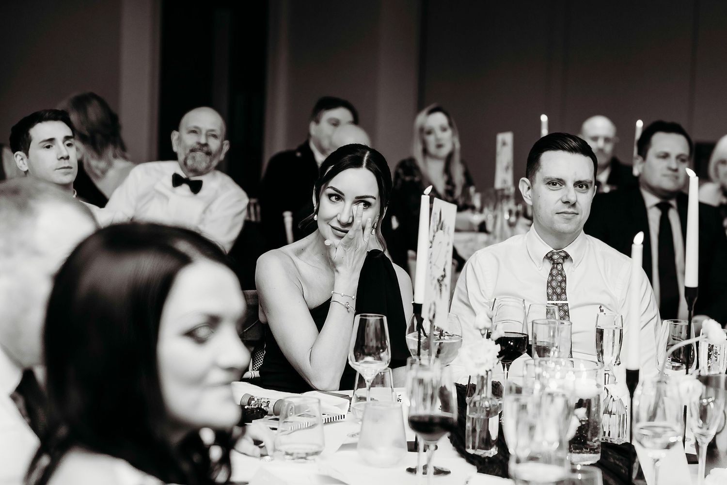 Candlelit wedding reception dinner table with guests enjoying and celebrating the intimate speeches at the Crow Wood Hotel and Spa, Burnley.