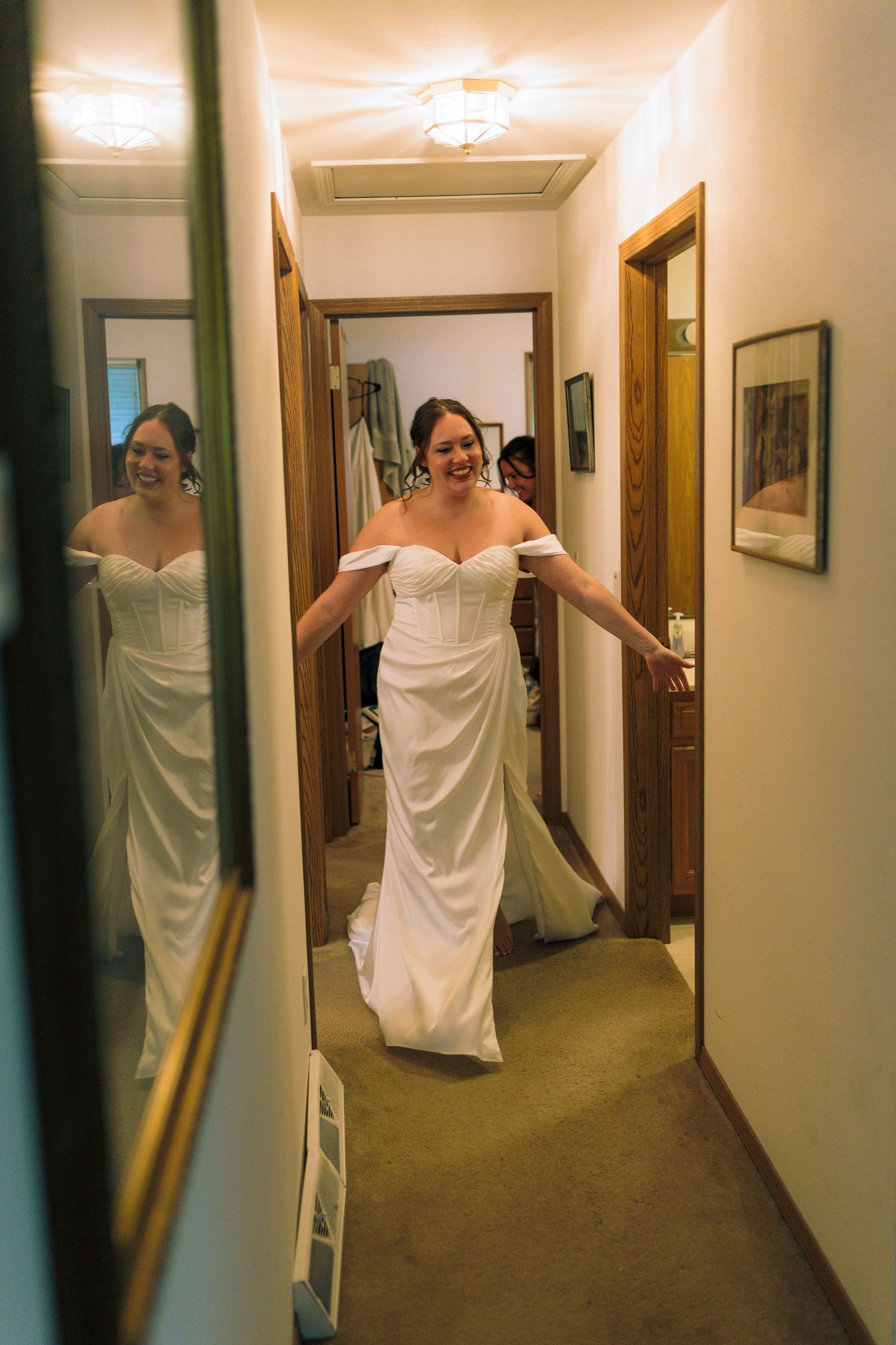 Person wrapped in white fabric running playfully down a hallway.