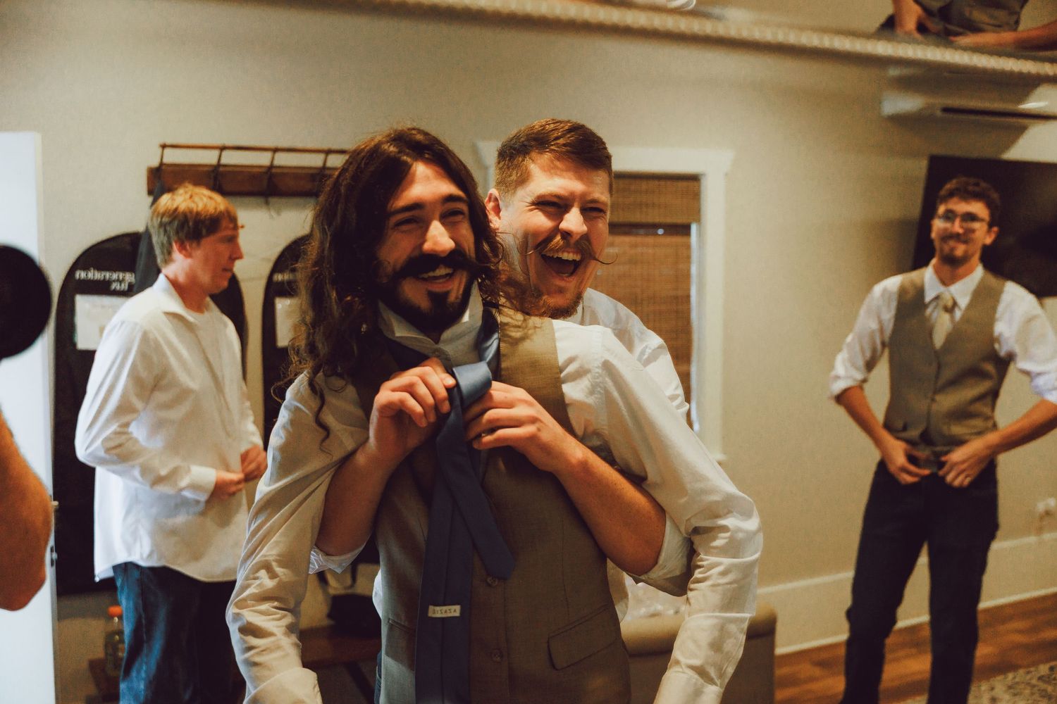 People dancing and celebrating in a casual indoor setting.