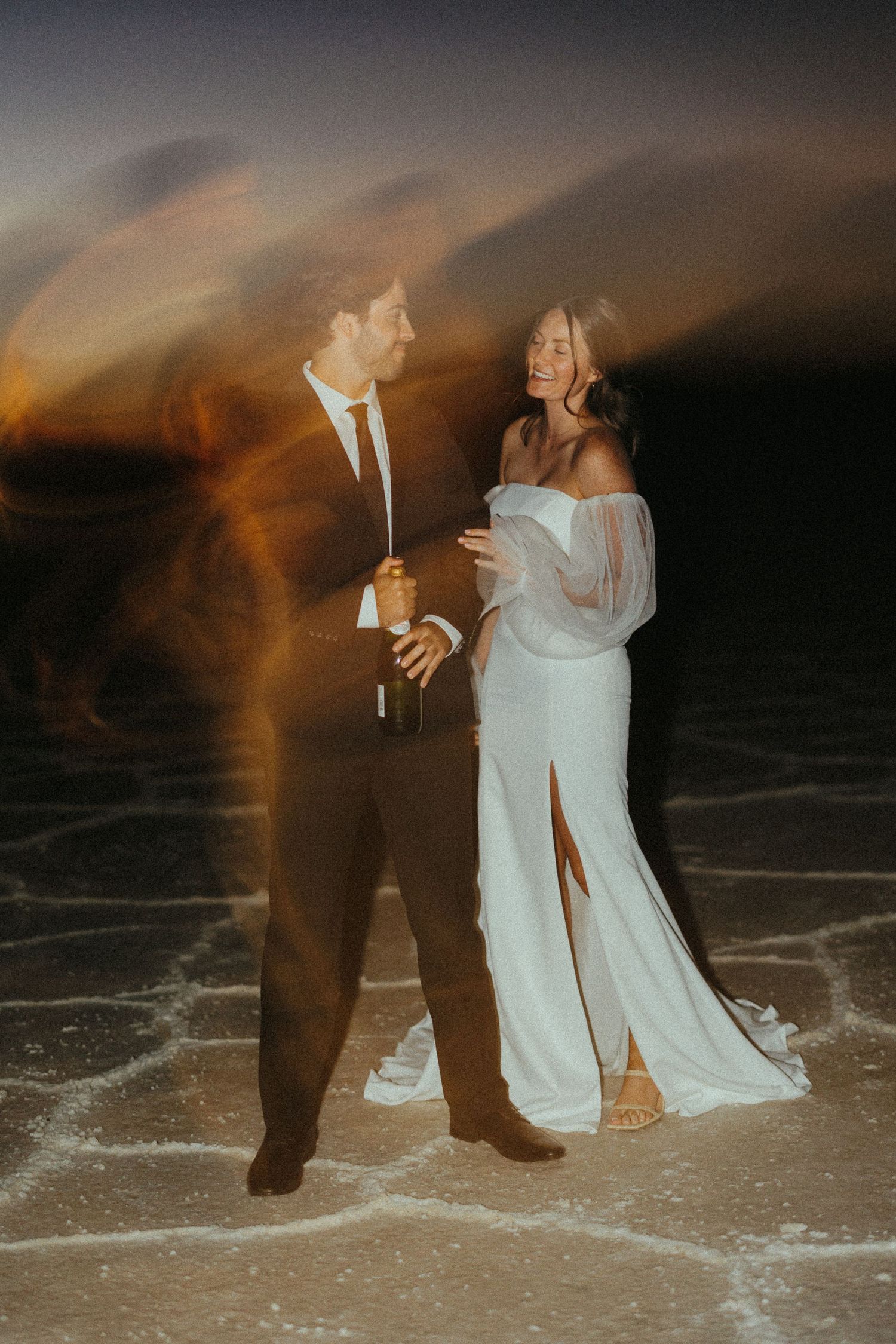 Long exposure wedding photos on utah salt flats creating ethereal motion blur effects.