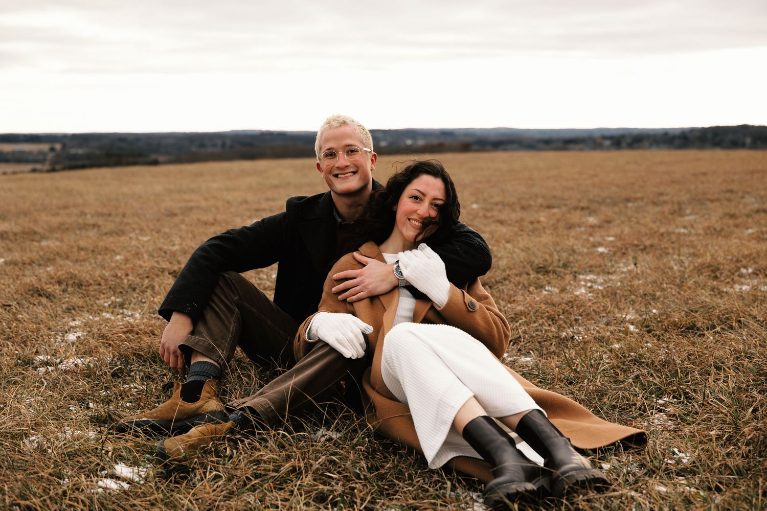 People enjoying playful moments together in a golden autumn field.