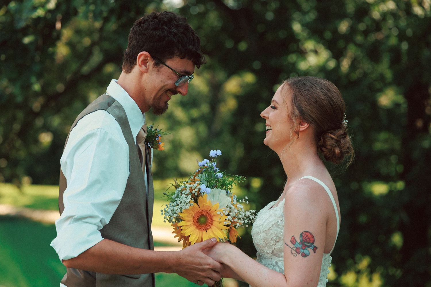 A couple sharing a romantic moment in a sunlit garden with sunflowers.