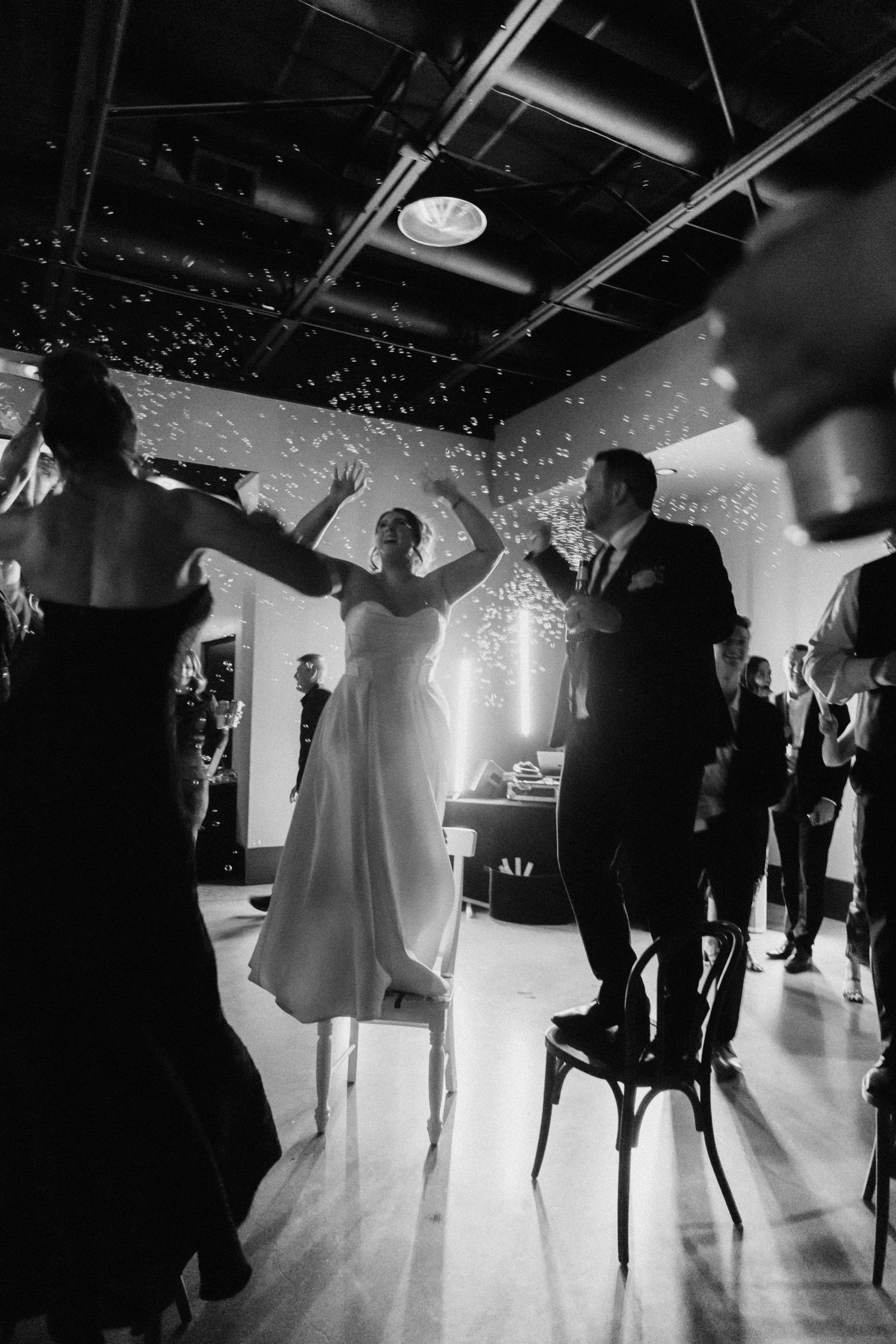 Wedding reception dance floor with silhouettes of guests and sparkly lighting effects.