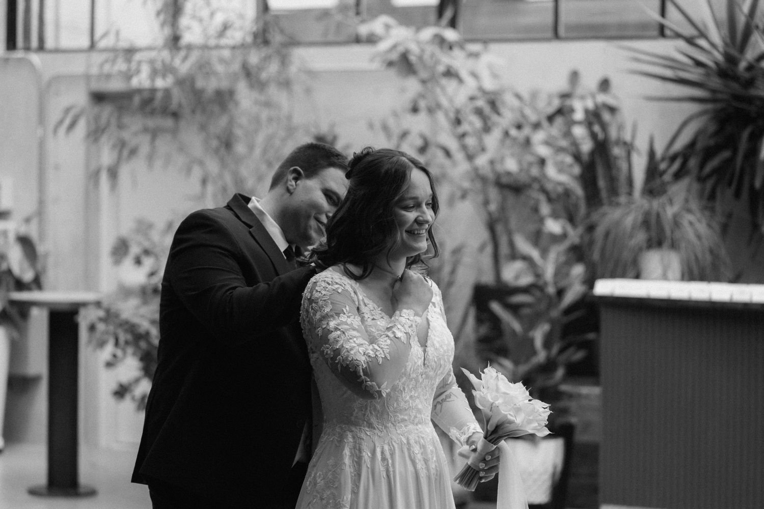 Romantic wedding moment photographed in an indoor setting.