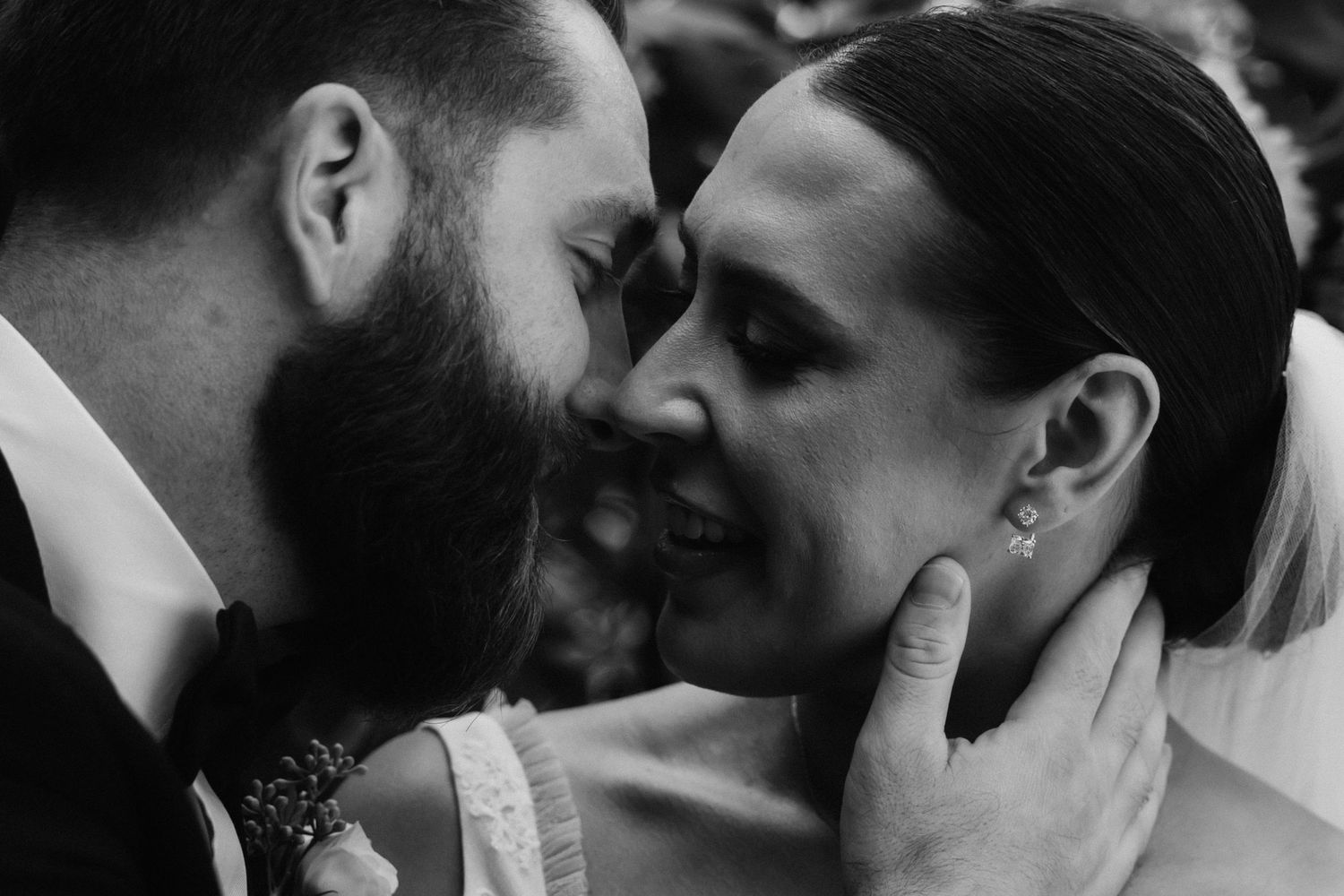 An intimate black and white moment shared between newlyweds.