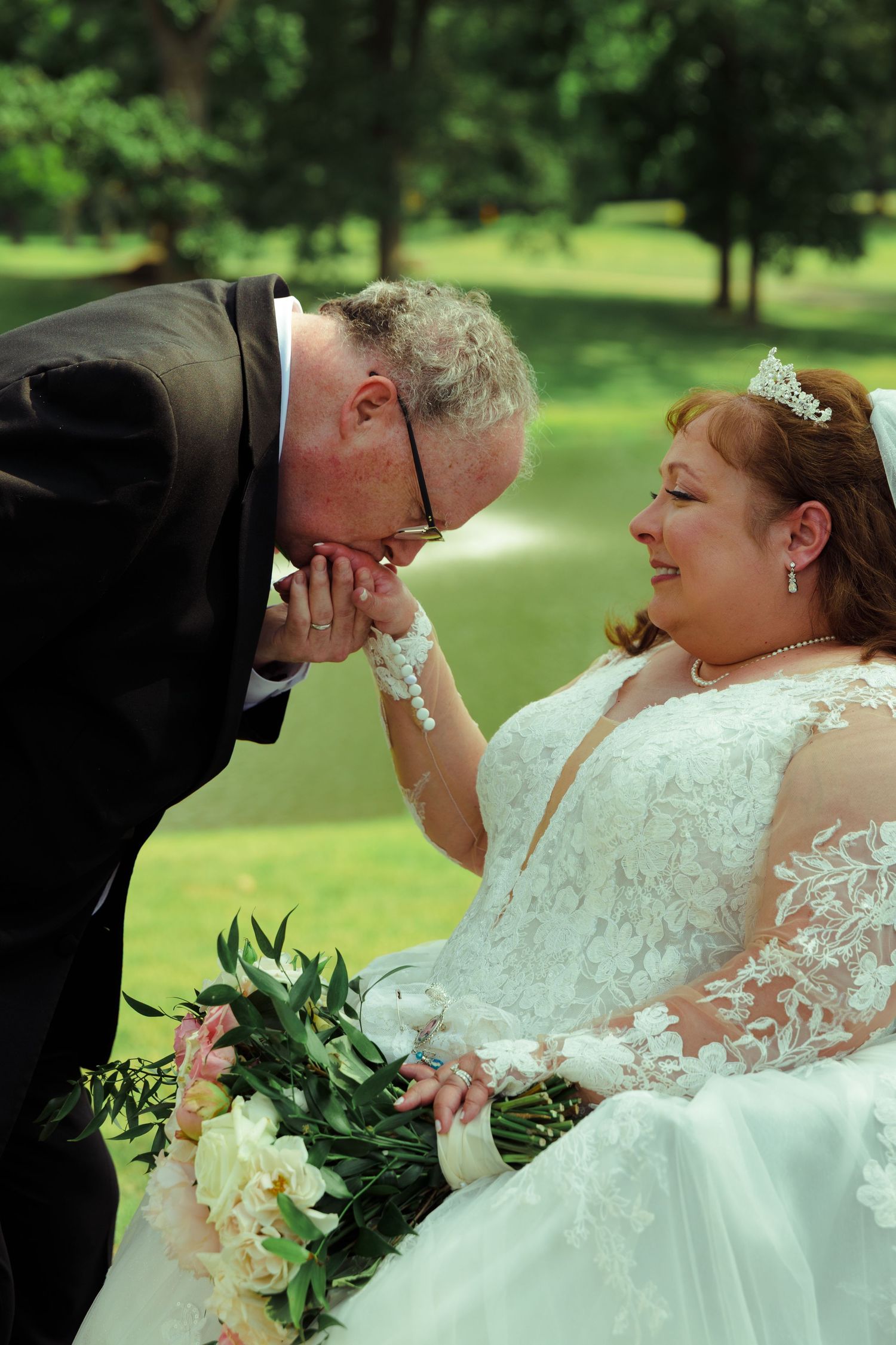 Romantic outdoor wedding photo session in a lush green garden setting.