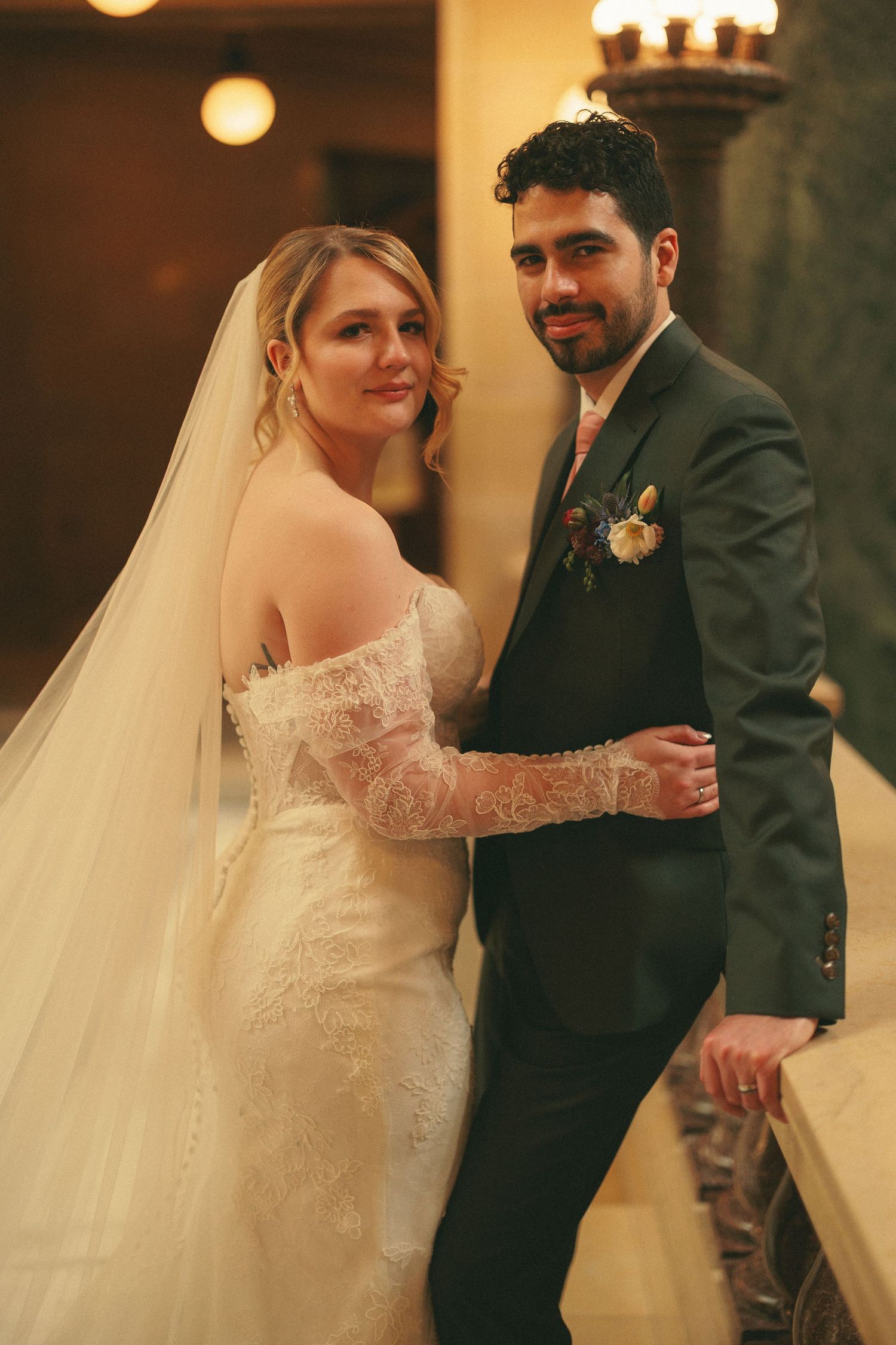 Romantic wedding dance captured in warm indoor lighting with flowing white dress.