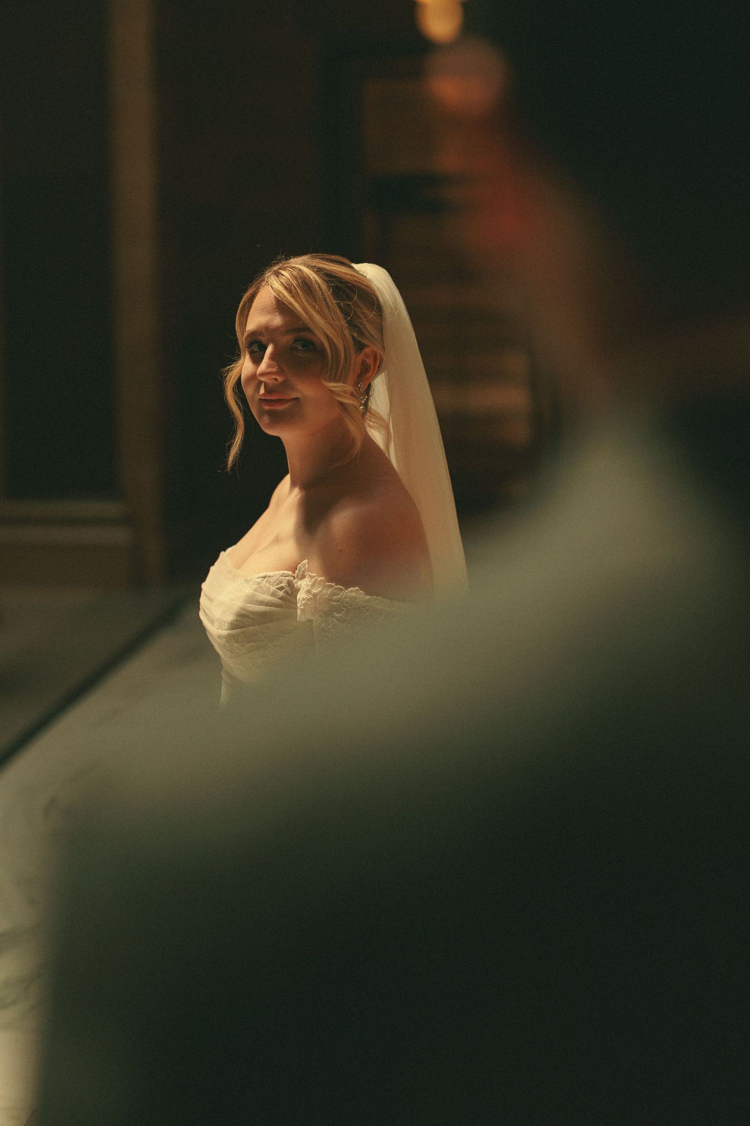Artistic close-up shots of a bride in white dress against dark background.