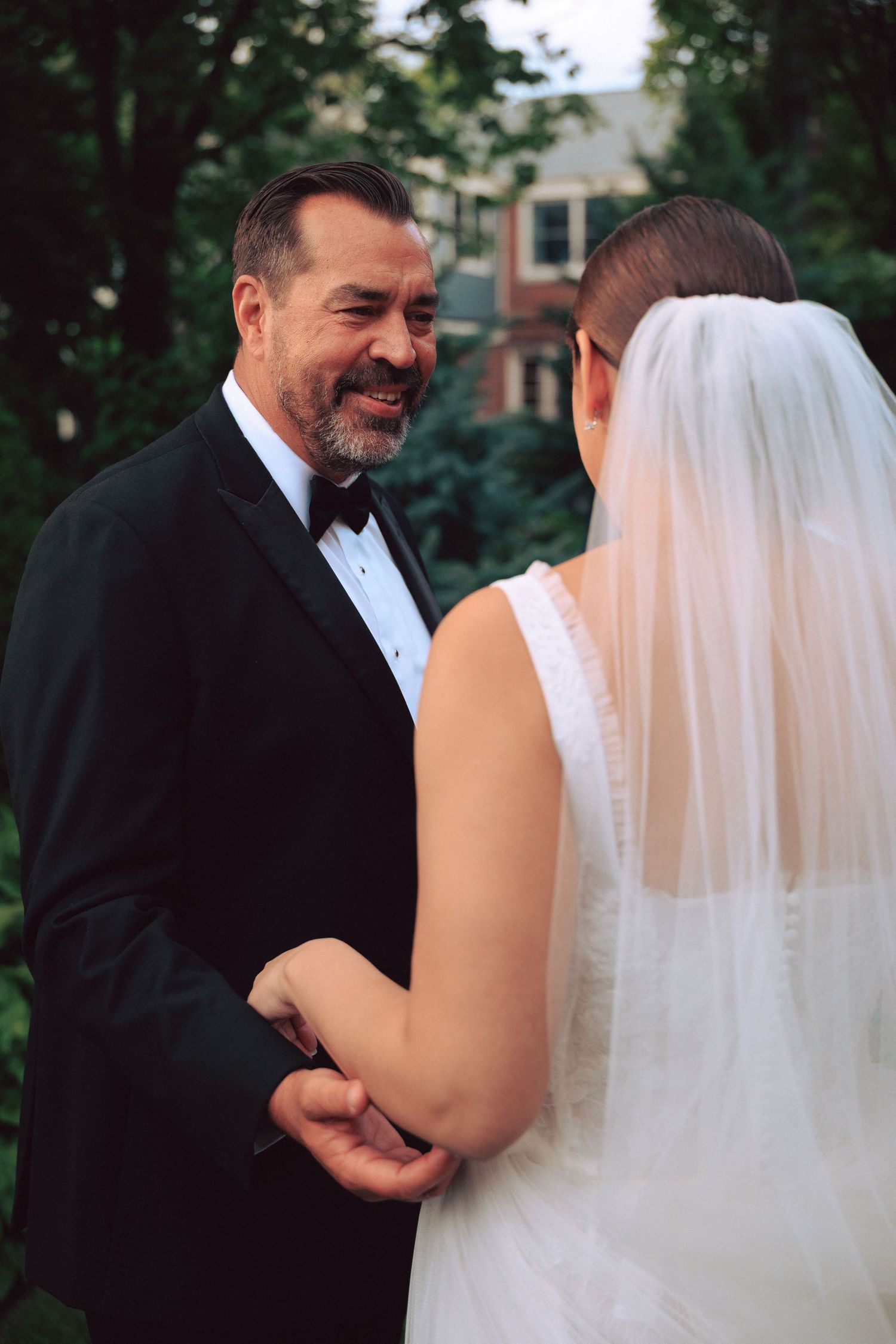A couple shares an intimate moment outdoors during their wedding celebration.