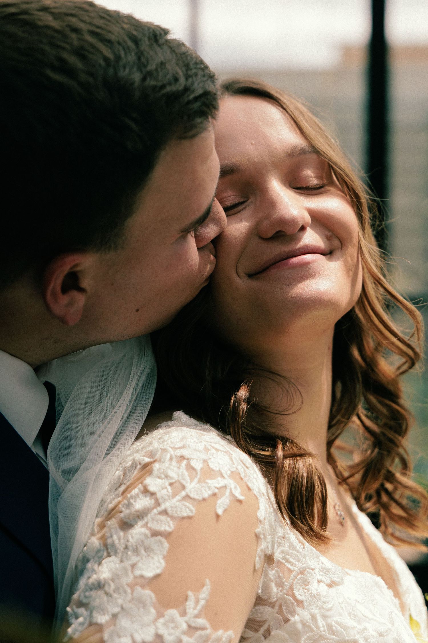 Intimate wedding portrait captured in soft natural lighting.
