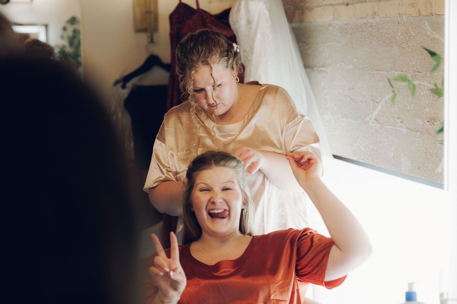 Candid moments of laughter and joy shared during wedding day preparations.