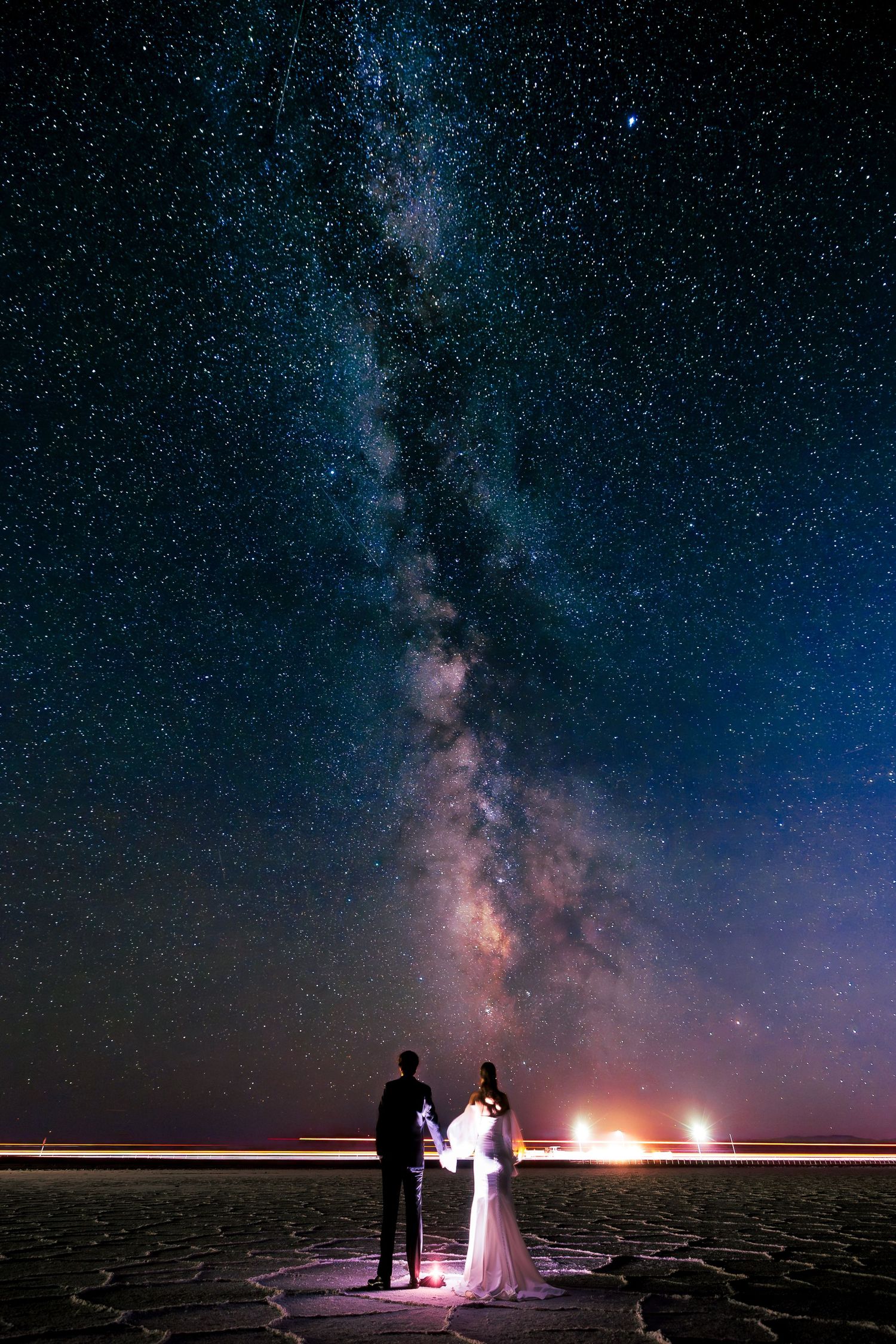 Wedding photography under starry night sky with Milky Way visible above utah salt flats.