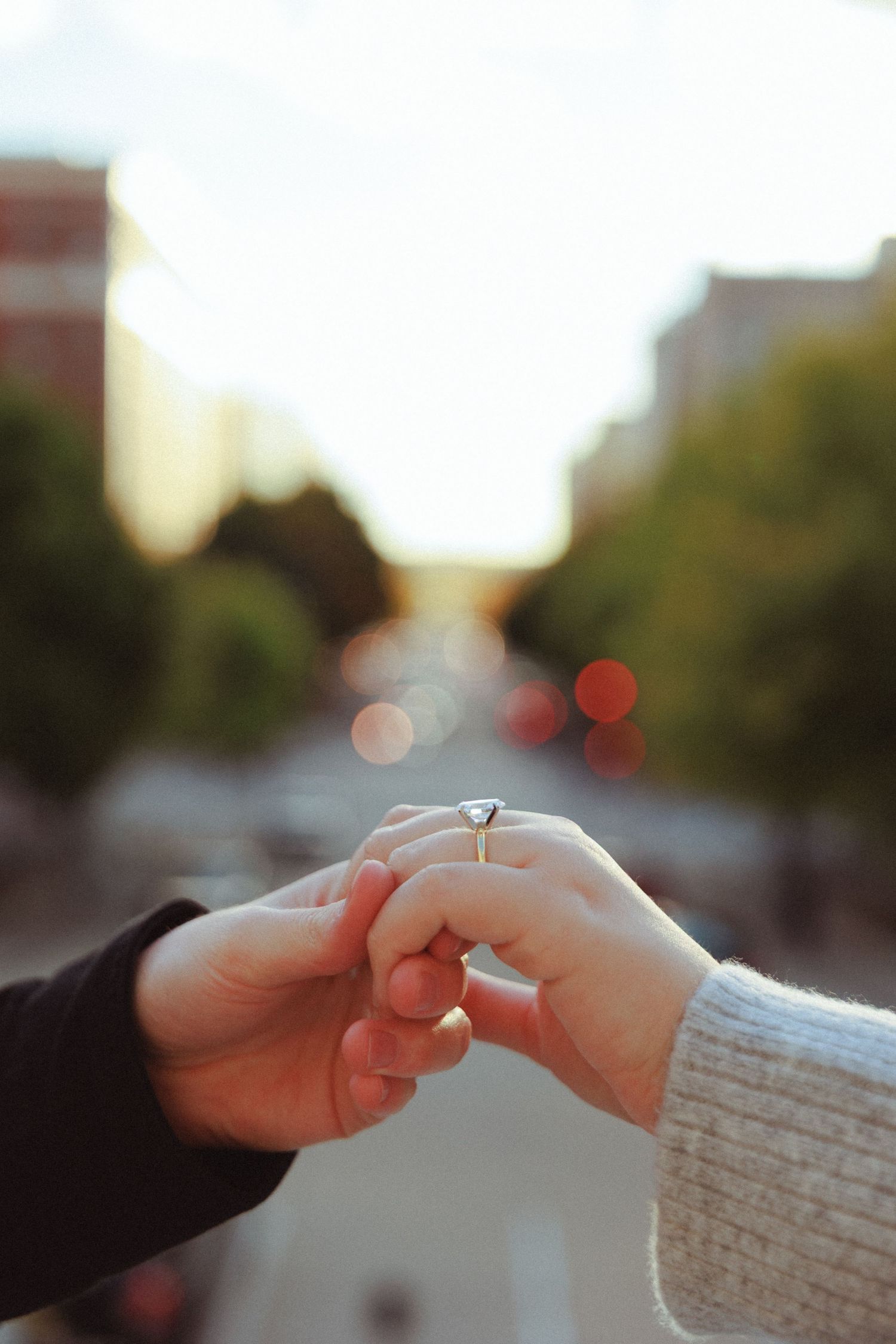 Close-up of hands exchanging a ring during a special moment.