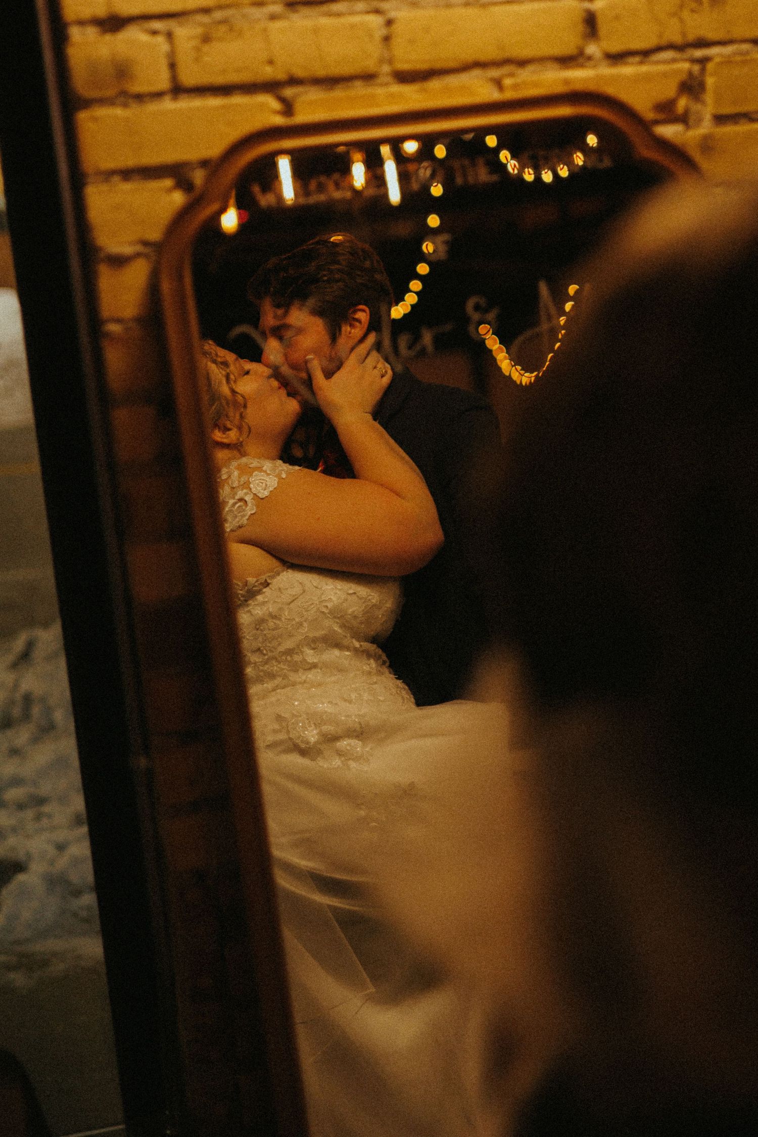 Romantic dance scene in a dimly lit venue with string lights.