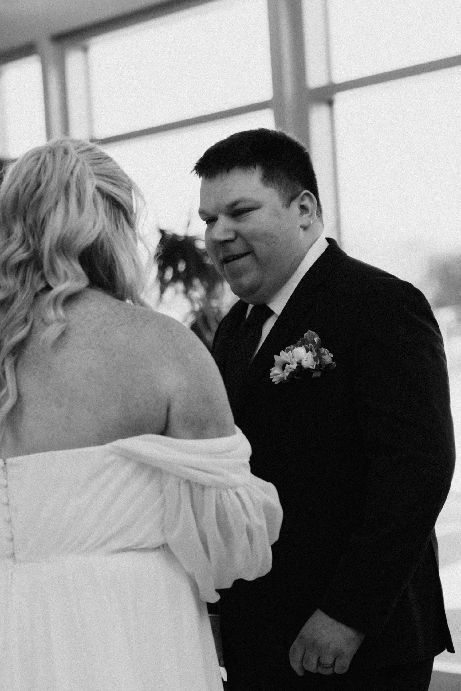 Black and white photo of a couple sharing an intimate dance moment at their wedding.