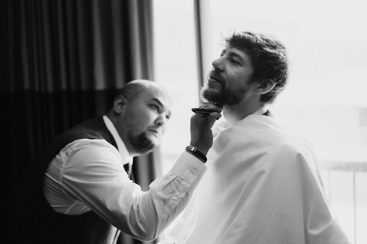 Black and white portraits capture intimate moments during wedding preparations.