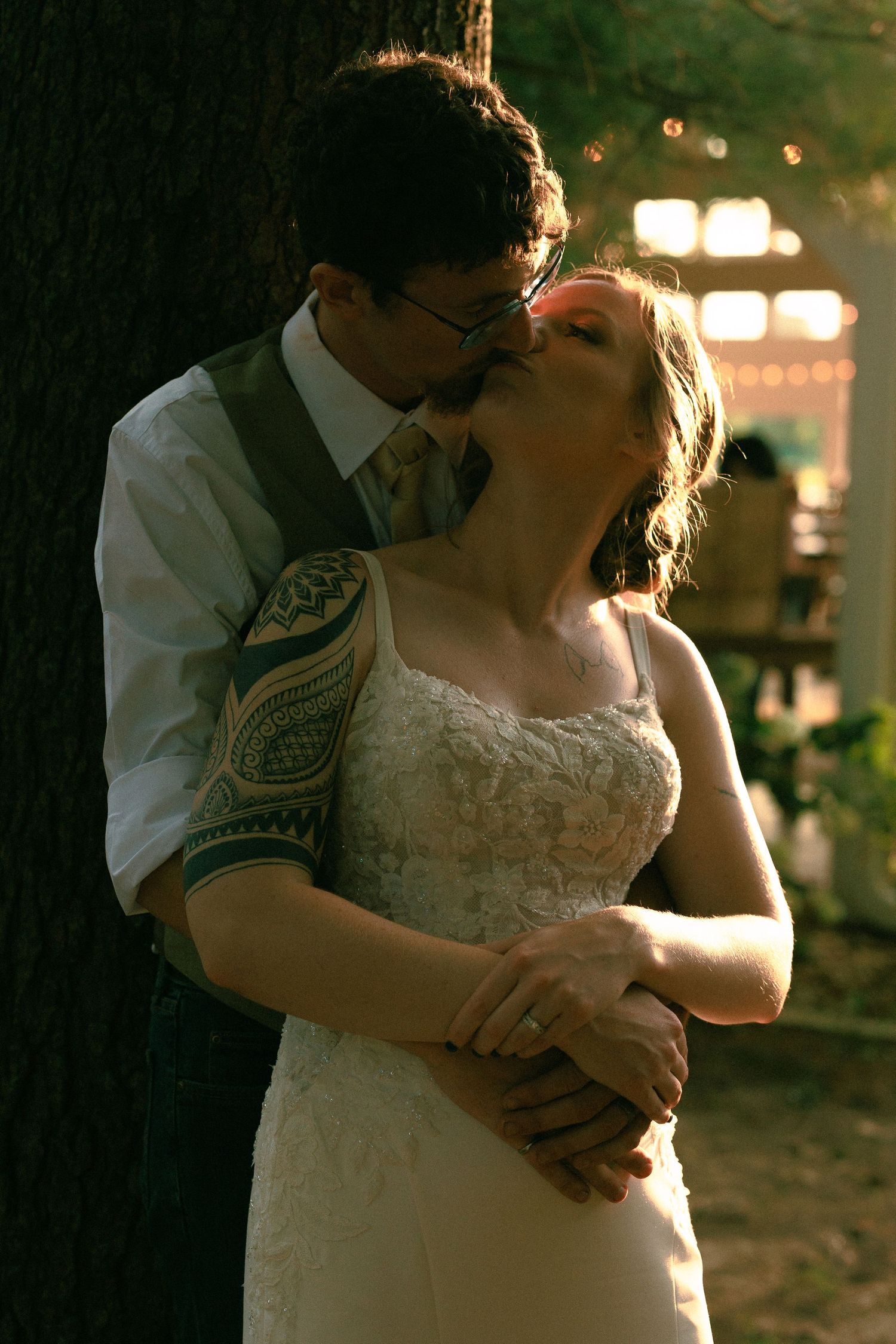 Couple shares an intimate dance in dim lighting with decorative arm tattoo visible.