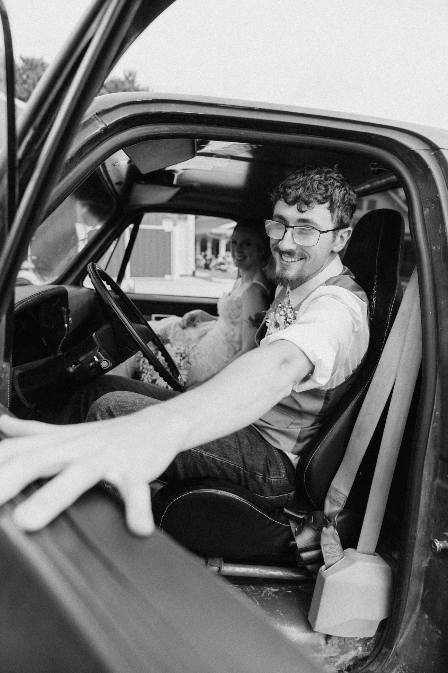 Black and white photo sequence of someone adjusting their position in a car.