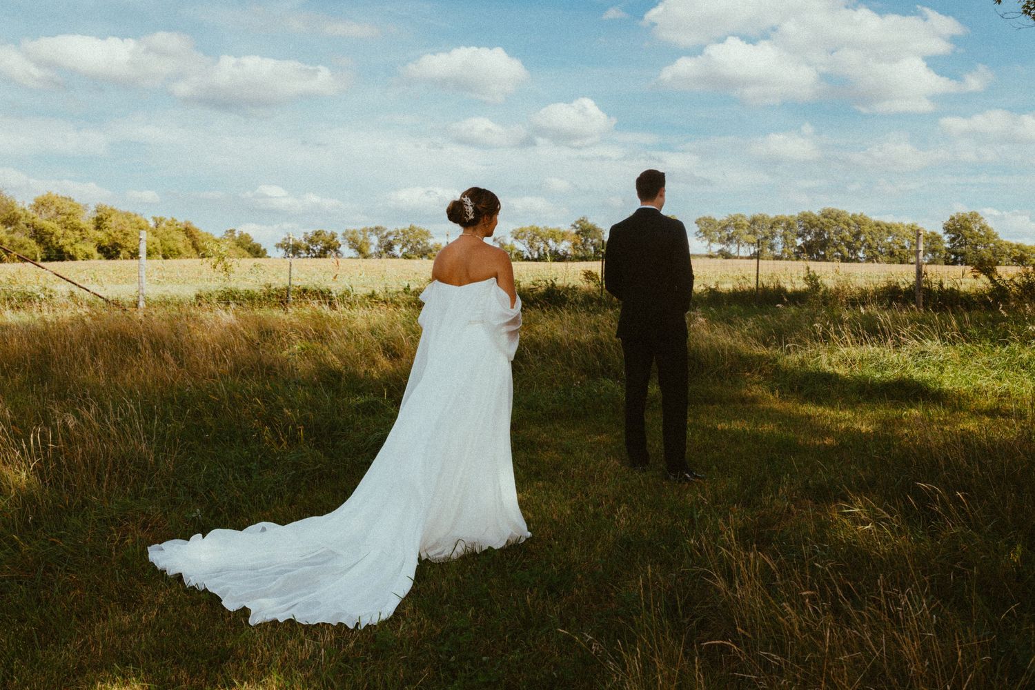 A romantic countryside wedding portrait with rolling hills and golden light.