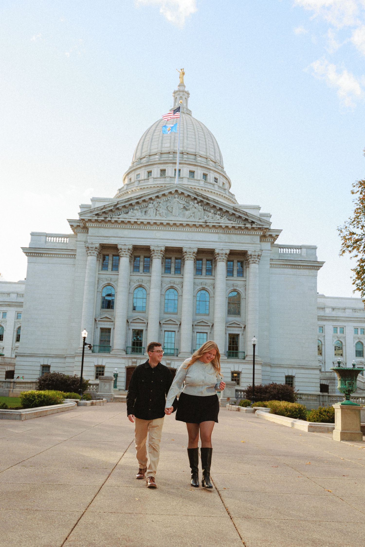 Couple walking together in front of the Wisconsin State Capitol building in Madison.
