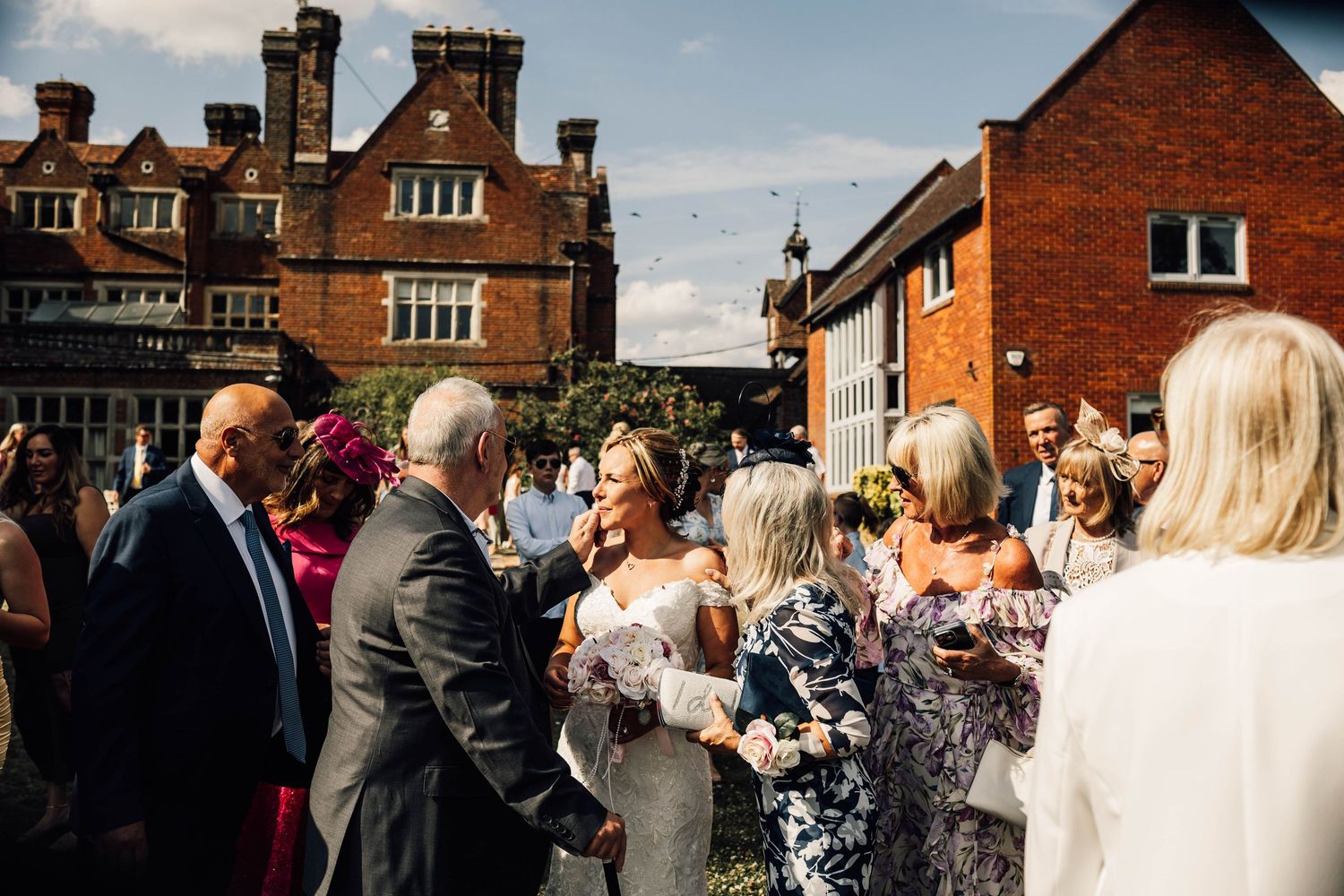 Pendall court, bletchingly, Surrey. listed wedding venue couple bride and groom confetti shot. wedding. evening reception. guests having fun