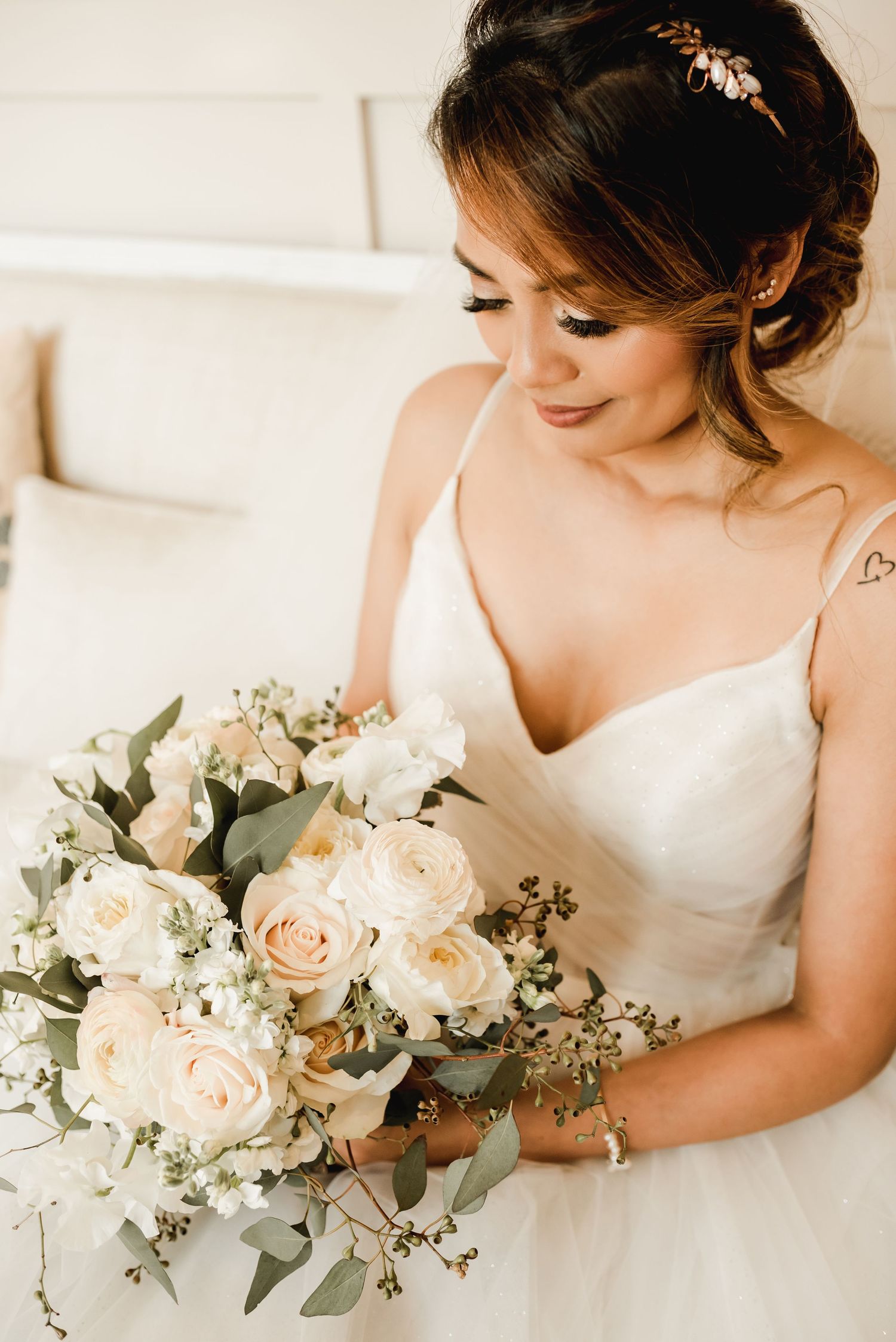 Elegant bridal bouquet featuring cream roses and eucalyptus greenery.