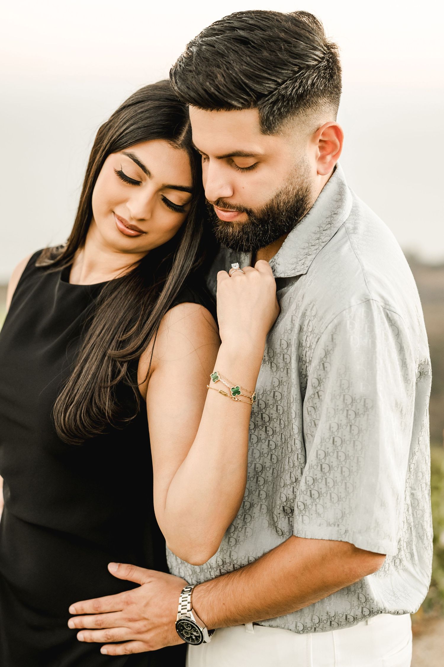 An intimate portrait of a couple sharing a tender moment during a sunset photoshoot.