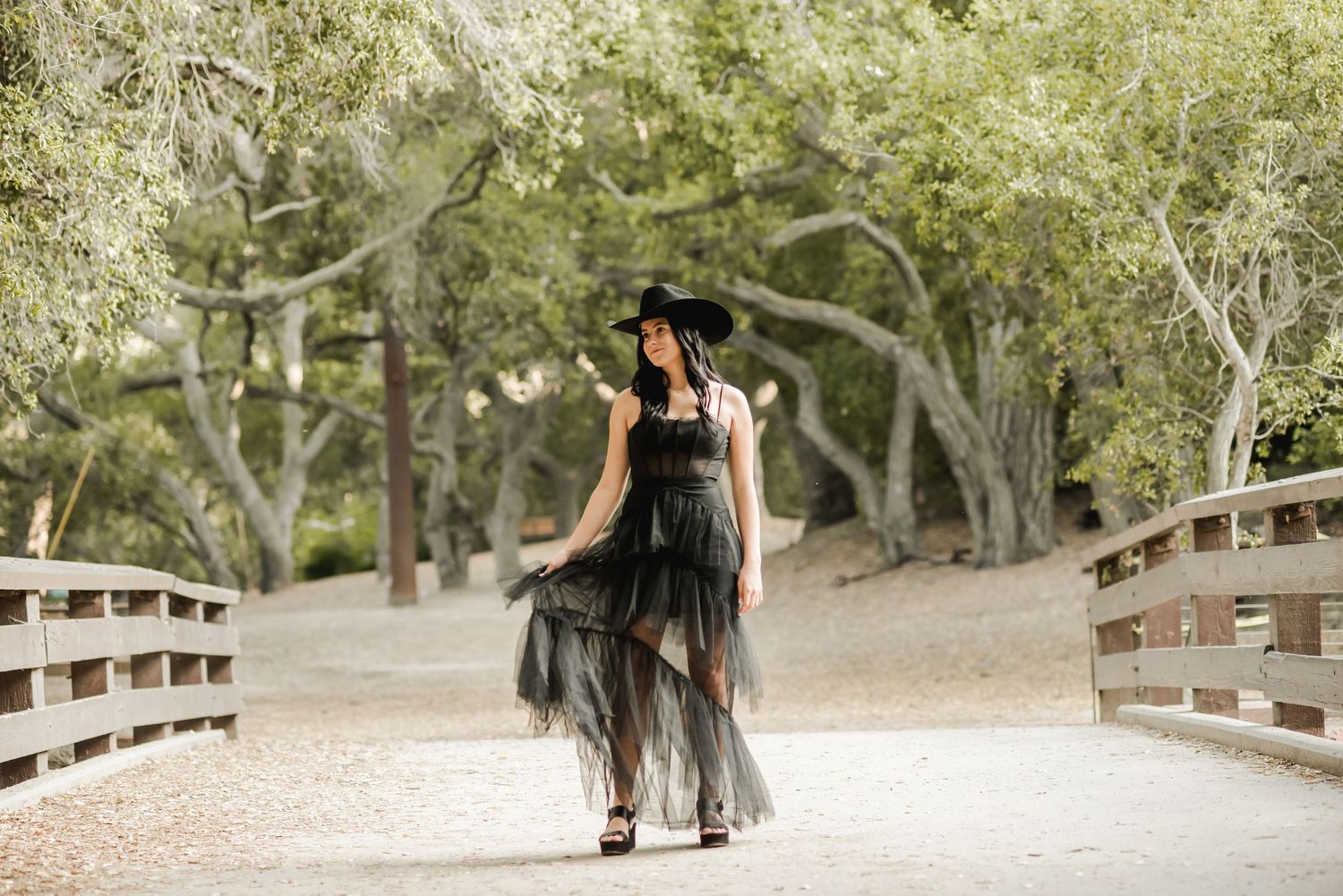 A series of outdoor portraits taken on a wooden bridge in a natural setting.
