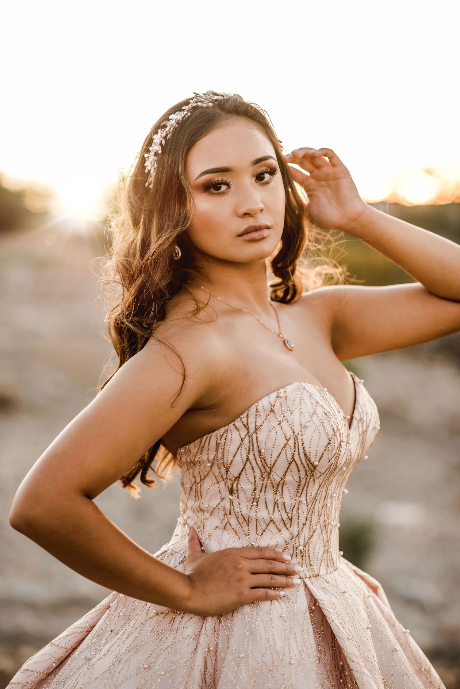 A formal gown sparkles in golden sunlight during a sunset portrait session.