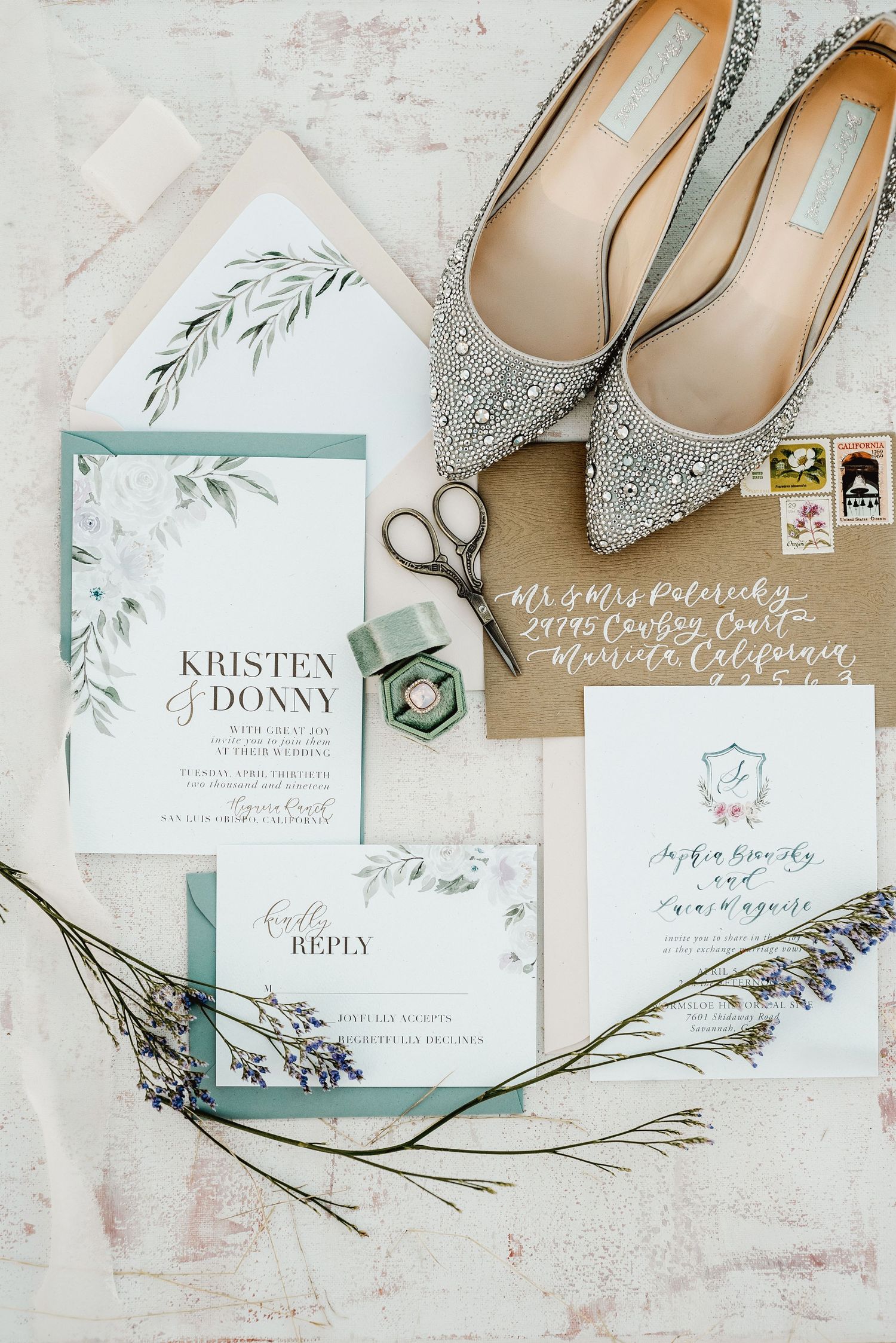 Wedding invitation suite in mint green with sparkly bridal shoes and floral accents.