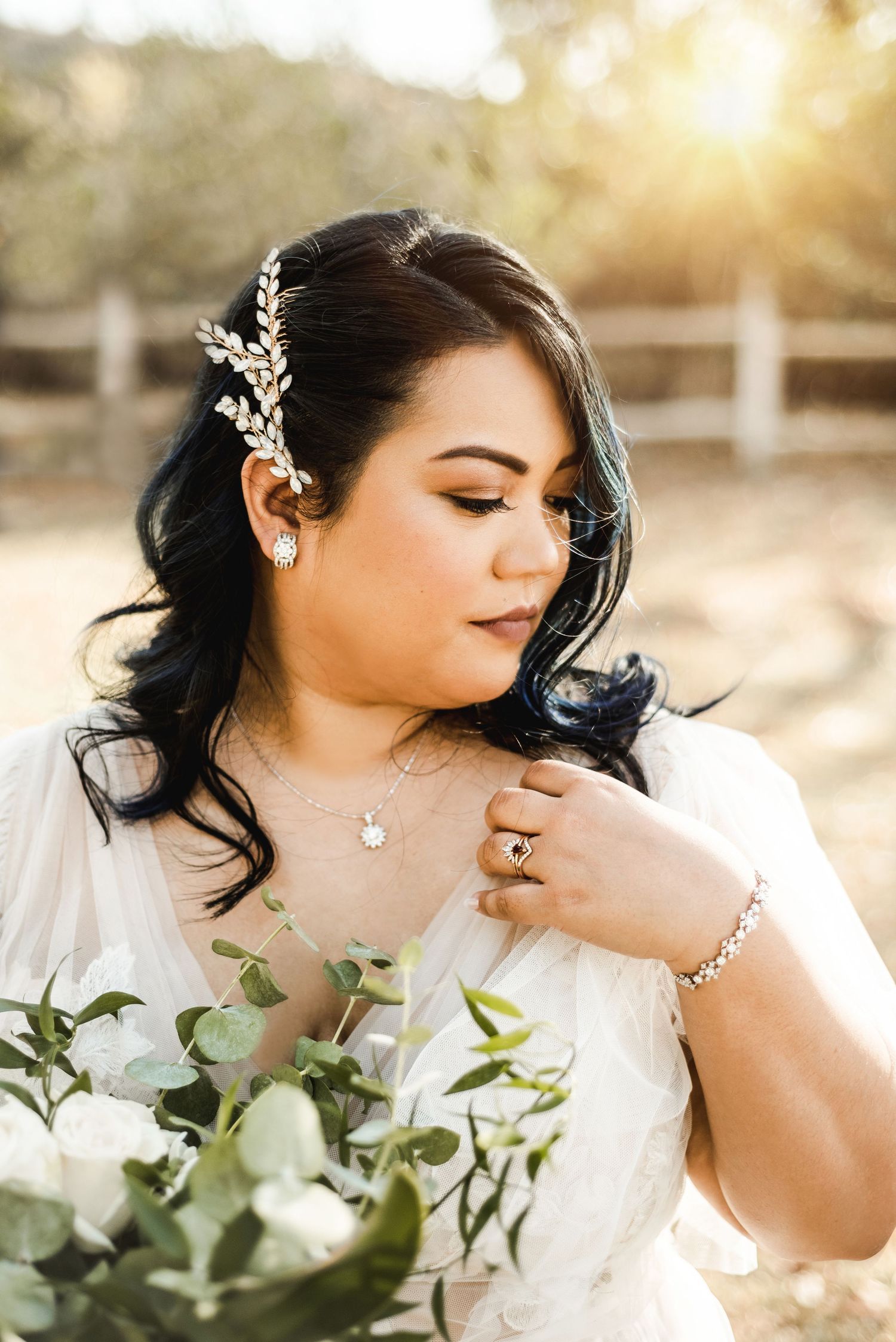 Romantic bridal portraits with delicate jewelry and flowing veil in golden sunlight.