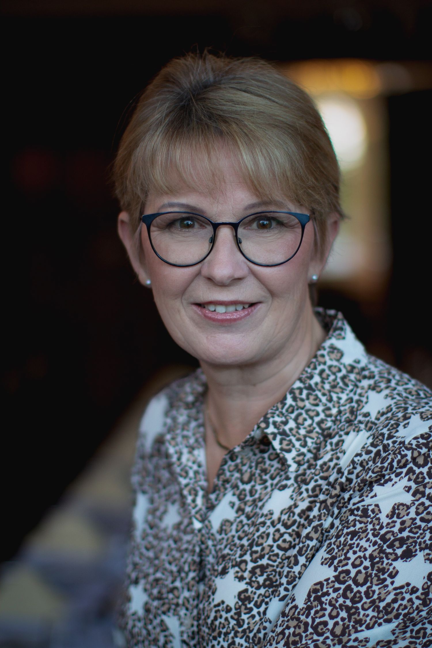 Colour portrait image of a client from Brickendon Grange Golf Club, for their committee photos. Smiles  with a soft background.