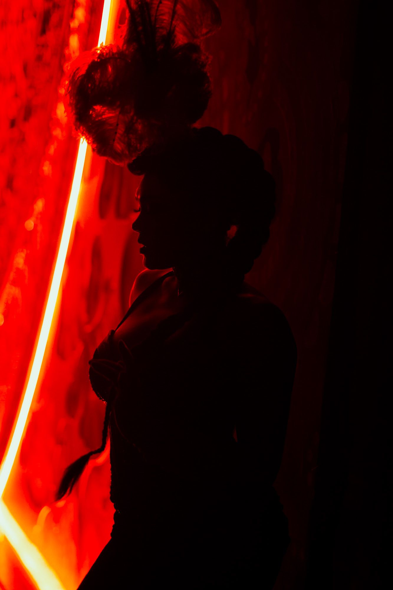 Colour image of one of a performer at Moulin Rouge! The Musical in London. Backstage image of a performer waiting in the wings. Silhouette.