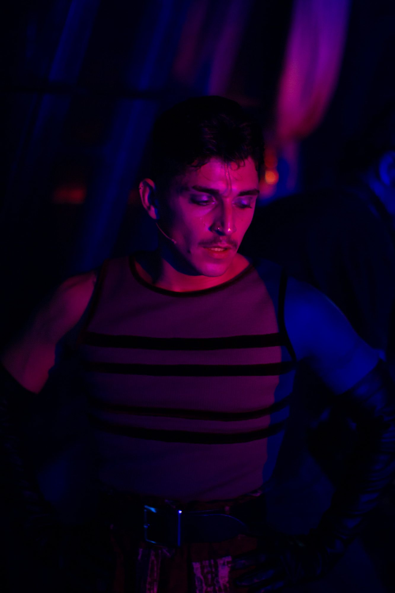 Colour image of one of a performer at Moulin Rouge! The Musical in London. Backstage image of a performer during a quick change.