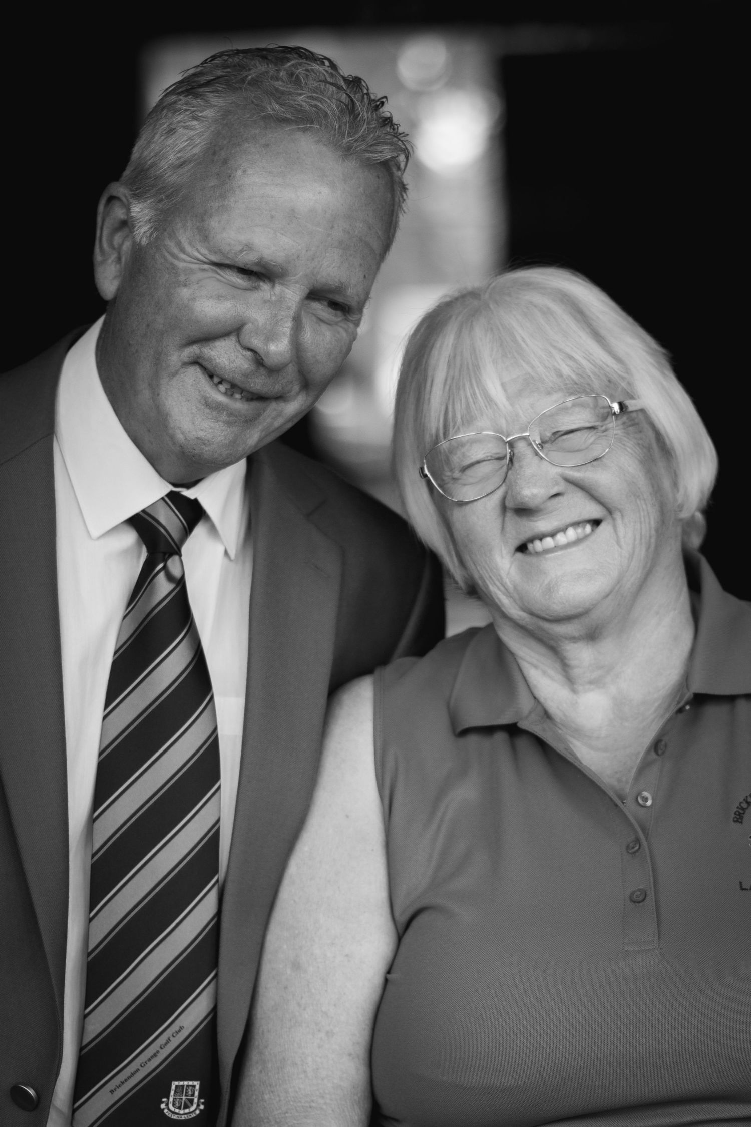 Black and white portrait image of two clients from Brickendon Grange Golf Club, for their committee photos. Smiles between the two clients.