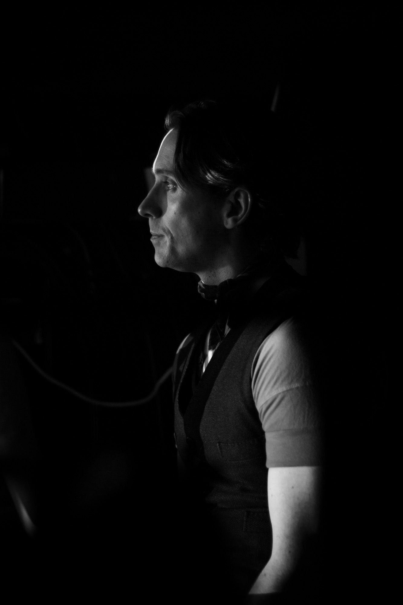 Black and white image of one of a performer at Moulin Rouge! The Musical in London. Backstage image of a performer waiting in the wings.