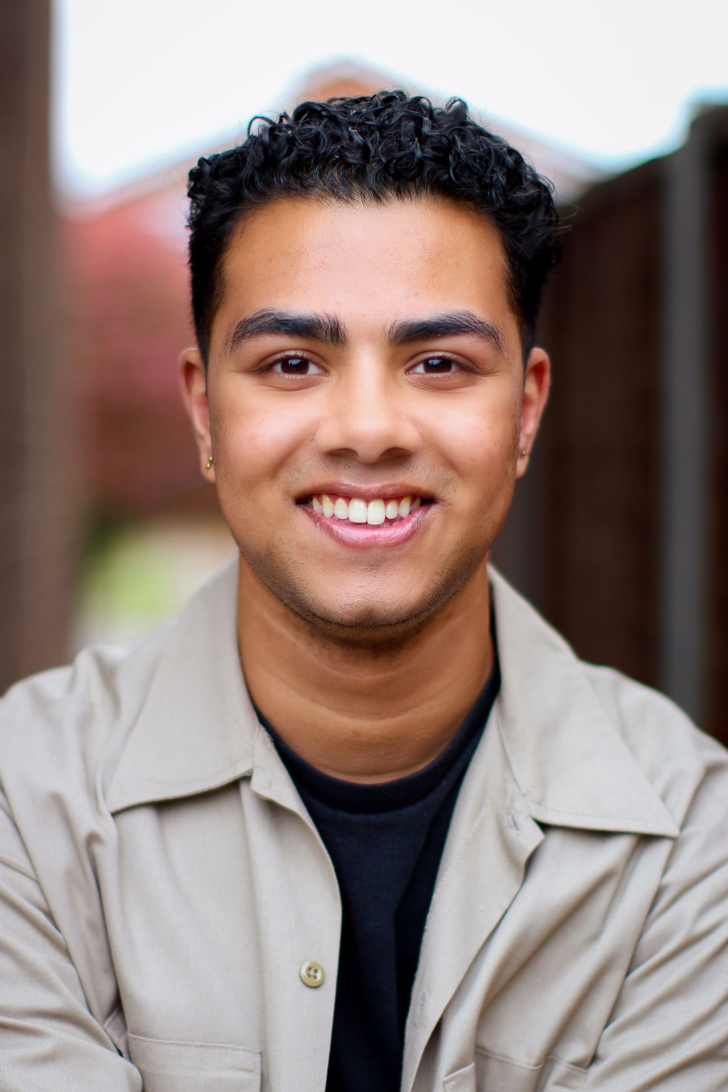 Colour portrait image of a client from for a headshot session. Smiles with a nice soft background, focusing just on the clients features